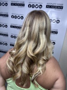 Introduction to blonding is my DNA, Blonde hair with curls at salon backdrop.