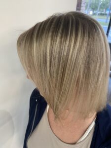Blonde bob hairstyle with side parting.