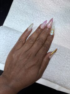 GI Bill-approved barbering school, FAFSA cosmetology and barber programs, Financial aid for hair and nail tech school, Barbering school GI Bill funding, Cosmetology training with FAFSA support, Hand with long, decorated acrylic nails.