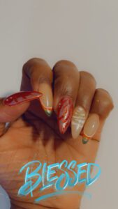 Hand with colorful, decorated nails, "Blessed" text.