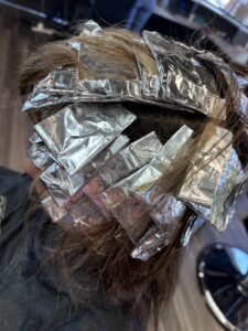 Hair with foils for highlighting treatment.