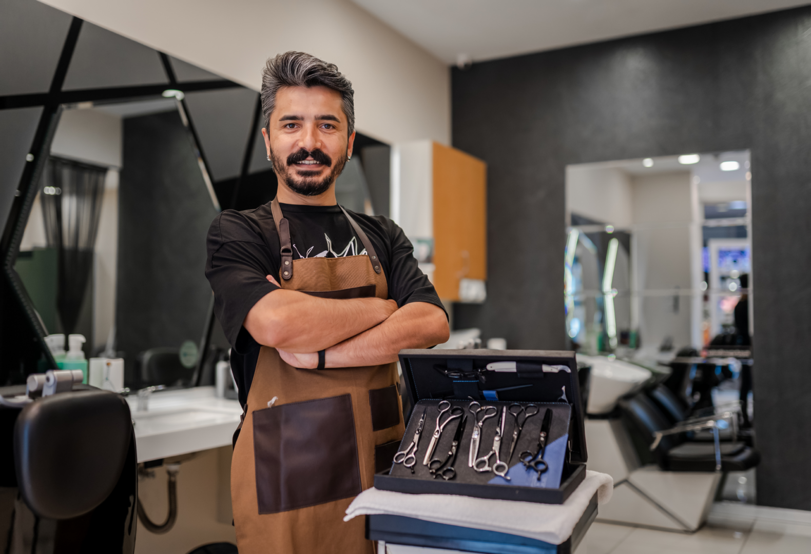 Hairdresser standing beside styling equipment