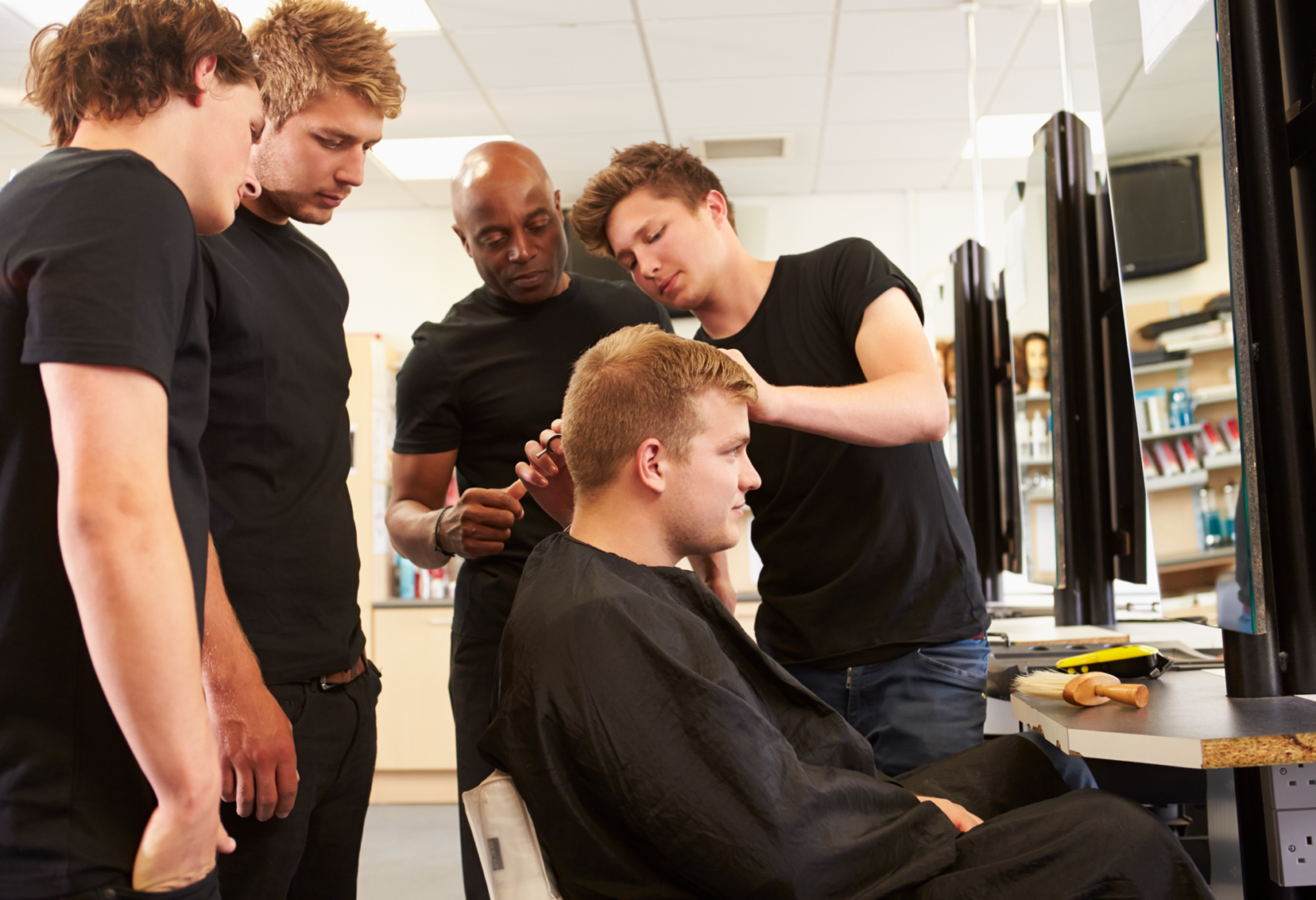 Barber training session with students watching