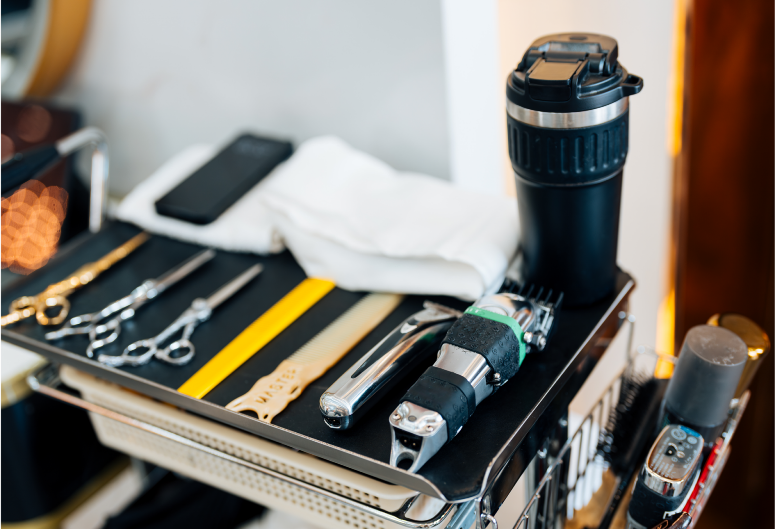 Barber tools and grooming equipment on cart.