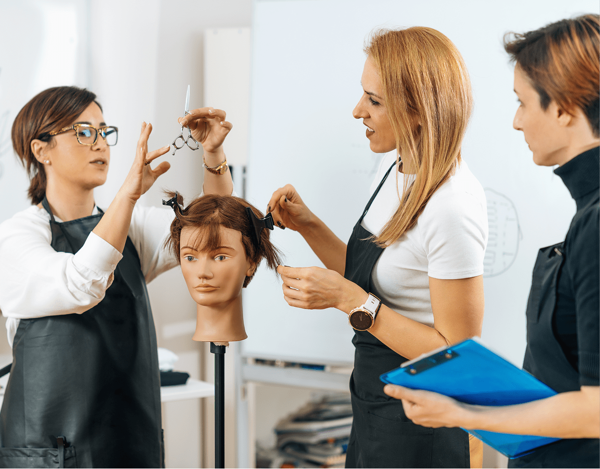 Hairdressing class with mannequin head practice